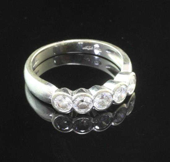 An 18ct white gold and five stone diamond half hoop ring, size O.